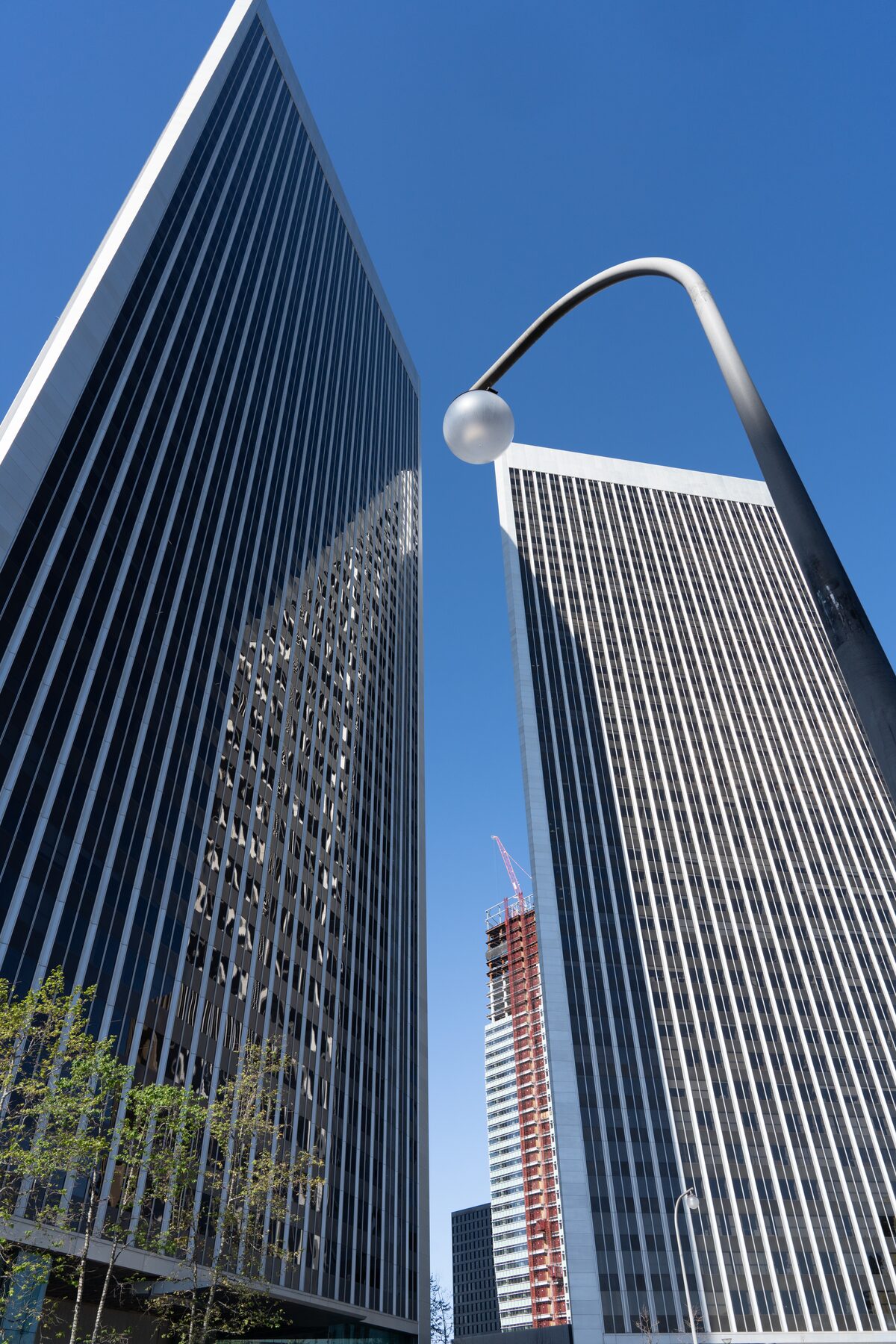 Twin 44-storey Century Plaza Towers seen from street level against a clear sky